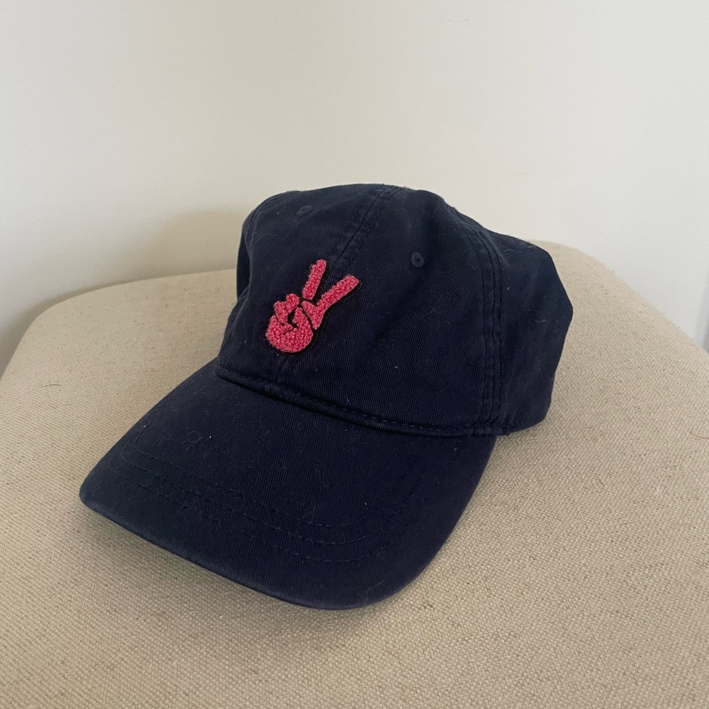 Navy blue hat with a pink peace sign